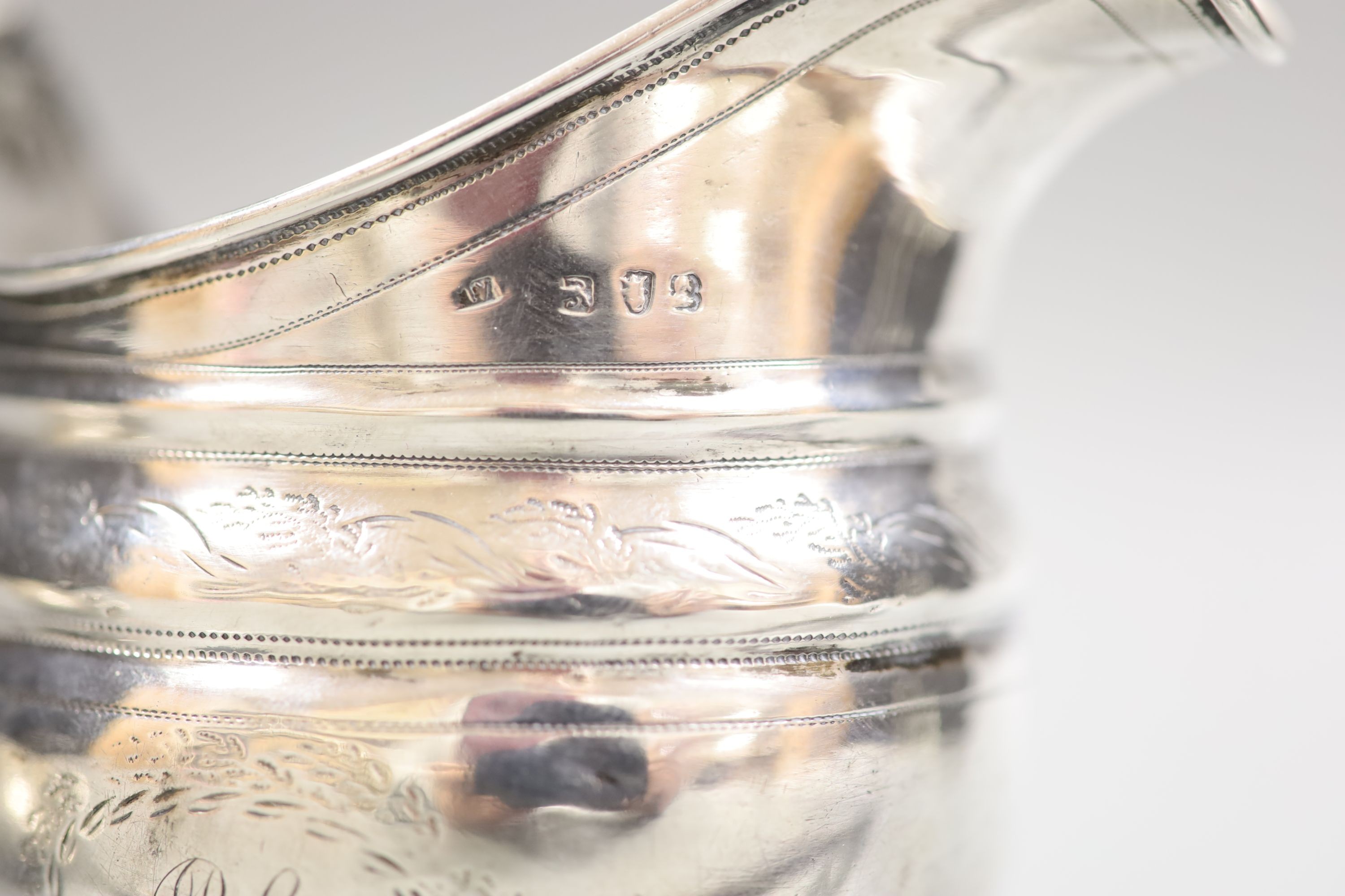 A George III silver cream jug, marks rubbed, height 10.7cm, and a 19th century toddy ladle.